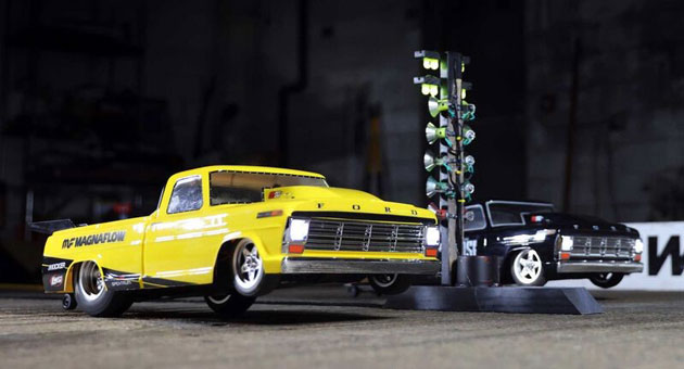 Losi remote control drag cars for adults launching off of the start line on a scale race track